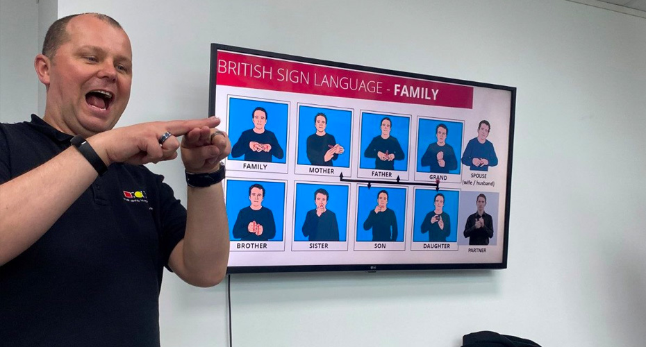 An image of a man delivering a session on sign language