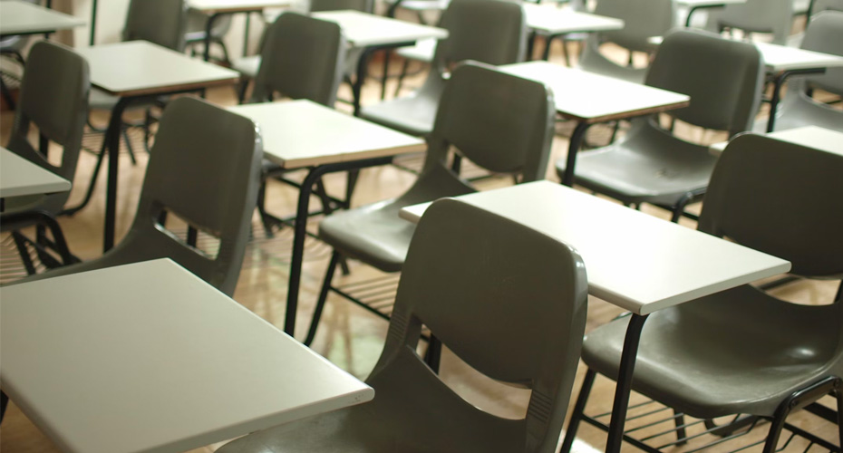 An image of small tables and chairs in an exam hall